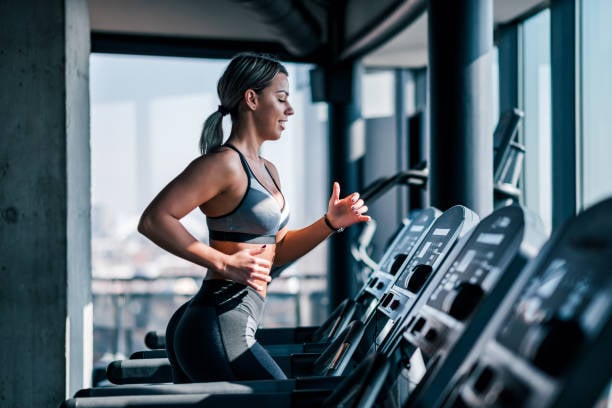 woman jogging treadmill bikini body